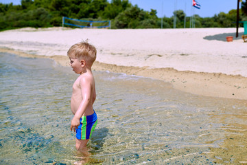 Toddler boy on beach