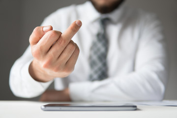 Businessman shows fuck you