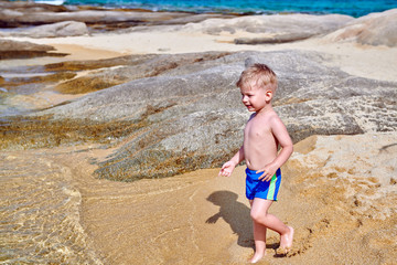 Toddler boy on beach