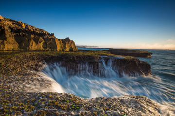 Wide angle landscape image of the dramatic sandstone rock formations along the coastline of Arniston in th Western Cape of South Africa.
