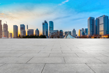 Obraz premium Empty Plaza Floor Bricks and the Skyline of Modern Urban Architecture in Qingdao..