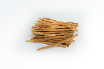 Natural toothbrush Miswak (Kayu Sugi) on white background with selective focus. It is a teeth cleaning twig made from the Salvadora persica tree and also know as miswaak, siwak, Sugi or sewak
