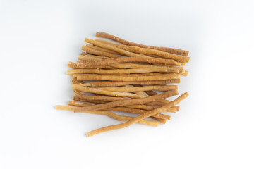 Natural toothbrush Miswak (Kayu Sugi) on white background with selective focus. It is a teeth cleaning twig made from the Salvadora persica tree and also know as miswaak, siwak, Sugi or sewak