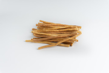 Natural toothbrush Miswak (Kayu Sugi) on white background with selective focus. It is a teeth cleaning twig made from the Salvadora persica tree and also know as miswaak, siwak, Sugi or sewak