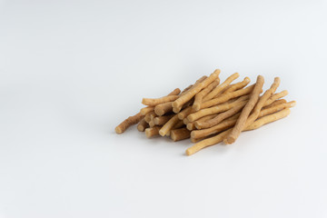 Natural toothbrush Miswak (Kayu Sugi) on white background with selective focus. It is a teeth cleaning twig made from the Salvadora persica tree and also know as miswaak, siwak, Sugi or sewak