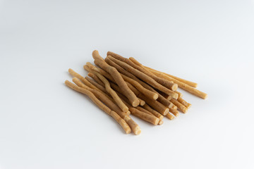Natural toothbrush Miswak (Kayu Sugi) on white background with selective focus. It is a teeth cleaning twig made from the Salvadora persica tree and also know as miswaak, siwak, Sugi or sewak
