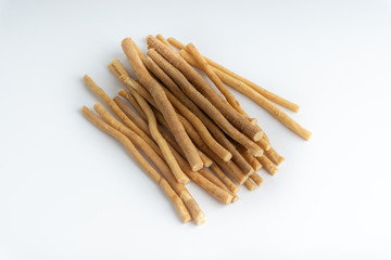 Natural toothbrush Miswak (Kayu Sugi) on white background with selective focus. It is a teeth cleaning twig made from the Salvadora persica tree and also know as miswaak, siwak, Sugi or sewak