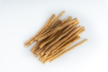 Natural toothbrush Miswak (Kayu Sugi) on white background with selective focus. It is a teeth cleaning twig made from the Salvadora persica tree and also know as miswaak, siwak, Sugi or sewak