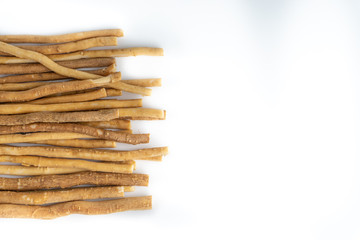 Natural toothbrush Miswak (Kayu Sugi) on white background with selective focus. It is a teeth cleaning twig made from the Salvadora persica tree and also know as miswaak, siwak, Sugi or sewak