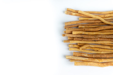 Natural toothbrush Miswak (Kayu Sugi) on white background with selective focus. It is a teeth cleaning twig made from the Salvadora persica tree and also know as miswaak, siwak, Sugi or sewak