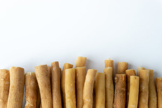 Natural toothbrush Miswak (Kayu Sugi) on white background with selective focus. It is a teeth cleaning twig made from the Salvadora persica tree and also know as miswaak, siwak, Sugi or sewak