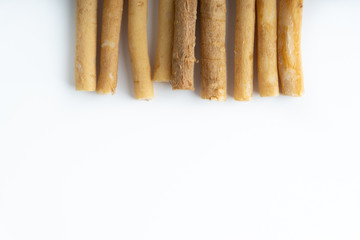 Natural toothbrush Miswak (Kayu Sugi) on white background with selective focus. It is a teeth cleaning twig made from the Salvadora persica tree and also know as miswaak, siwak, Sugi or sewak