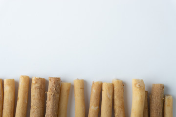 Natural toothbrush Miswak (Kayu Sugi) on white background with selective focus. It is a teeth cleaning twig made from the Salvadora persica tree and also know as miswaak, siwak, Sugi or sewak