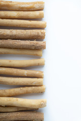 Natural toothbrush Miswak (Kayu Sugi) on white background with selective focus. It is a teeth cleaning twig made from the Salvadora persica tree and also know as miswaak, siwak, Sugi or sewak