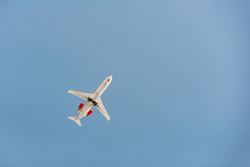 A jet airplaine is flying in the sky at sunset