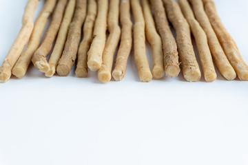 Natural toothbrush Miswak (Kayu Sugi) on white background with selective focus. It is a teeth cleaning twig made from the Salvadora persica tree and also know as miswaak, siwak, Sugi or sewak