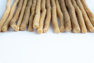 Natural toothbrush Miswak (Kayu Sugi) on white background with selective focus. It is a teeth cleaning twig made from the Salvadora persica tree and also know as miswaak, siwak, Sugi or sewak