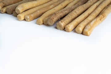 Natural toothbrush Miswak (Kayu Sugi) on white background with selective focus. It is a teeth cleaning twig made from the Salvadora persica tree and also know as miswaak, siwak, Sugi or sewak