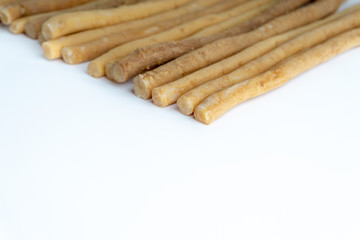 Natural toothbrush Miswak (Kayu Sugi) on white background with selective focus. It is a teeth cleaning twig made from the Salvadora persica tree and also know as miswaak, siwak, Sugi or sewak