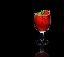 Strawberry cocktail with crushed ice on a black background