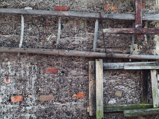 A wooden ladder on an old wall