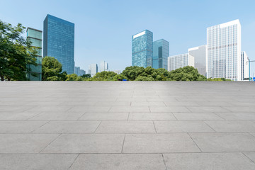 Empty Plaza floor tiles and the skyline of modern urban buildings in Hangzhou..