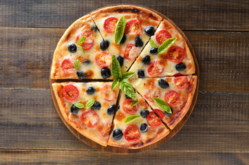 Sliced pizza with tomato and olives