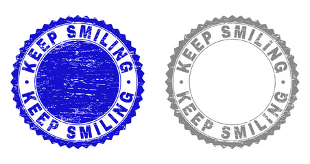 Obraz premium Grunge KEEP SMILING stamp seals isolated on a white background. Rosette seals with grunge texture in blue and grey colors. Vector rubber stamp imprint of KEEP SMILING caption inside round rosette.