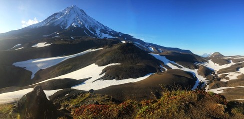 View of the Koryaksky volcano on a sunny day. Koryaksky or Koryakskaya Sopka is an active volcano on the Kamchatka Peninsula in the Russian Far East.
