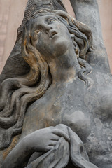 Facade statue of sensual Rococo Era woman at New Palace in Potsdam, Germany, details, closeup