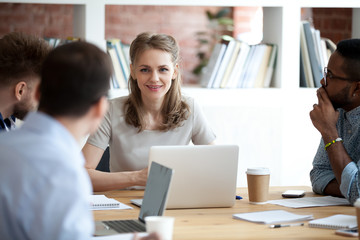 Female executive leader boss leading corporate multi-ethnic team meeting