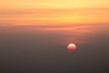 Beautiful sunset or sunrise sky above clouds with dramatic light.