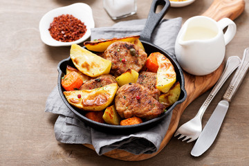 Pork meat medallions with baked potatoes and cream sauce .