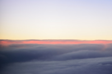 The blue skyline with cloudy in sunrise time, view from window on the plane.