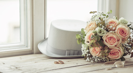 Marriage day composition of hat, rings and bouquet