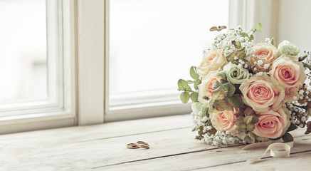 Pair of wedding rings and bridal bouquet - Powered by Adobe