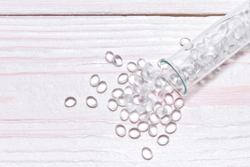 Transparent Polyethylene granules on wooden background.The concept of free bpa. HDPE Plastic...