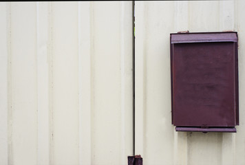 iron mailbox hanging on a light wall