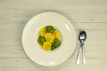 Cassic ravioli filled with basilico and cheese in a plate.