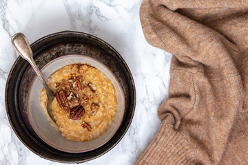 Oat porridge topped with pecan nuts and sweet Potatoes