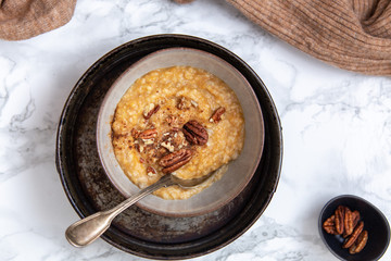 Oat porridge topped with pecan nuts and sweet Potatoes