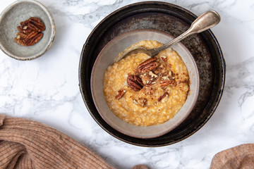 Oat porridge topped with pecan nuts and sweet Potatoes