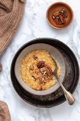 Oat porridge topped with pecan nuts and sweet Potatoes