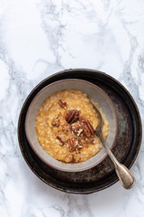 Oat porridge topped with pecan nuts and sweet Potatoes