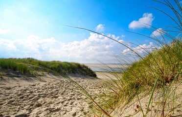 Dune beach on the North Sea island Langeoog in Germany with clouds on a beautiful summer day,...