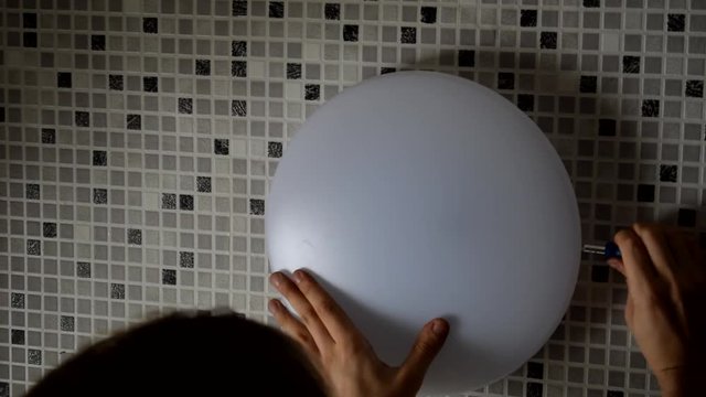 Electrician replacing old wall lamp