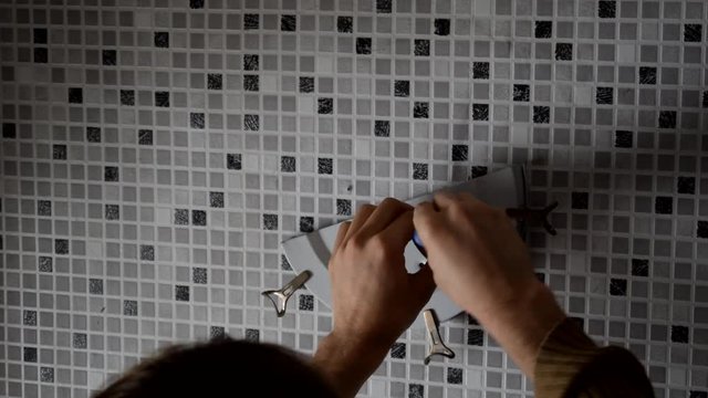 Electrician replacing old wall lamp
