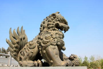 Fototapeta na wymiar copper lion sculpture in a park, China