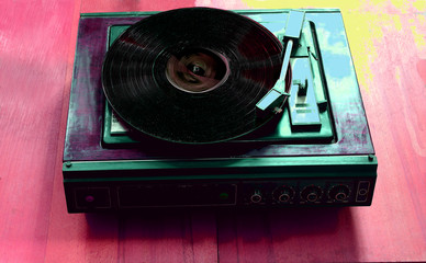 Vintage record player with vinyl disc, close-up.