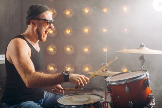 talented emotional man plays the drums in studio . close up photo. hobby, lifestyle